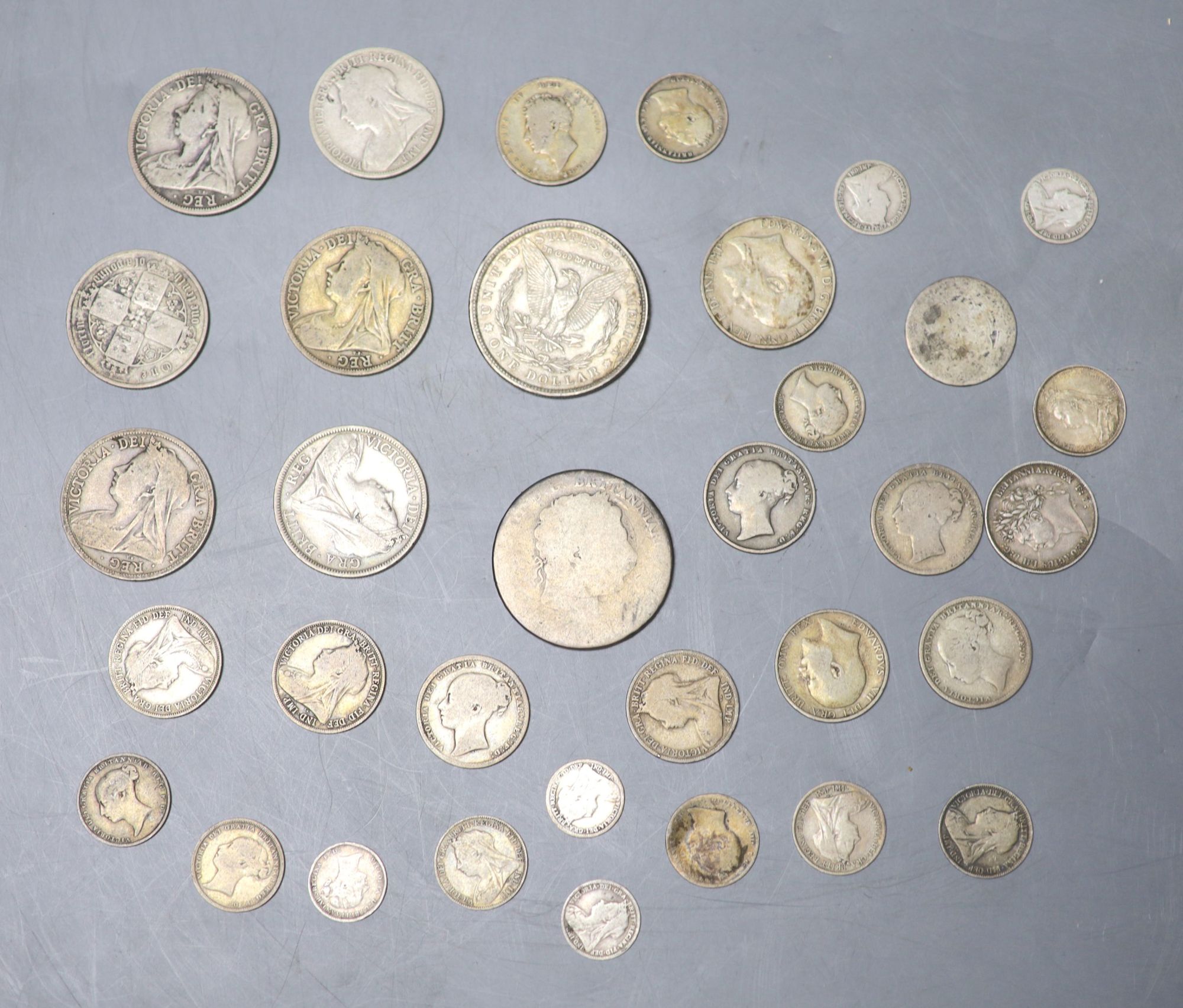 A collection of UK and world coins including George IV - George V silver threepences to halfcrowns